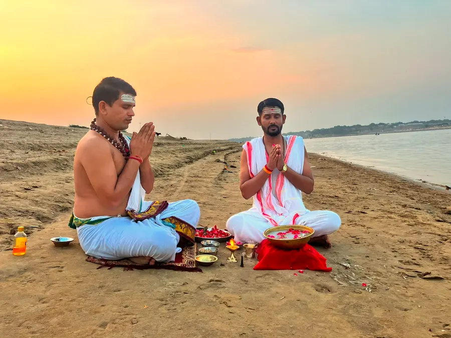 Priests performing a Vedic Yagya ceremony on the riverbank sand